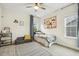 Bedroom with a patterned rug, yellow accents, and natural light from the window at 145 Cassada Ct, Holly Springs, NC 27540
