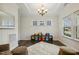 Well-lit bonus room with dark wood floors, a tray ceiling, neutral walls, and great natural light at 145 Cassada Ct, Holly Springs, NC 27540
