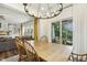 Dining room with a wooden table, chandelier, and sliding doors to a covered patio at 145 Cassada Ct, Holly Springs, NC 27540