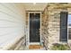 Charming front entrance featuring a stone facade, decorative lanterns, and a welcoming atmosphere at 145 Cassada Ct, Holly Springs, NC 27540