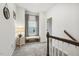 Hallway with a bench under a window, complemented by a decorative mirror and wooden banister at 145 Cassada Ct, Holly Springs, NC 27540