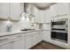Beautiful kitchen with stainless steel appliances, white cabinets, and tile backsplash at 145 Cassada Ct, Holly Springs, NC 27540
