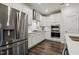Modern kitchen with stainless steel refrigerator, oven, and white cabinets at 145 Cassada Ct, Holly Springs, NC 27540