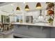 Kitchen island featuring sleek countertops, modern lighting, and a dining area at 145 Cassada Ct, Holly Springs, NC 27540