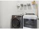 Laundry room with a front loading washer and dryer, and wire shelving at 145 Cassada Ct, Holly Springs, NC 27540
