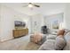 Comfortable living room area with large sectional couch, TV, and natural light at 145 Cassada Ct, Holly Springs, NC 27540