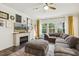 Cozy living room with a fireplace and large sectional sofa, creating a comfortable gathering space at 145 Cassada Ct, Holly Springs, NC 27540