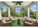 Relaxing screened-in porch with wicker seating and a view of the lush backyard at 145 Cassada Ct, Holly Springs, NC 27540