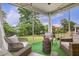 Outdoor patio featuring wicker furniture, turf flooring, and picturesque backyard views at 145 Cassada Ct, Holly Springs, NC 27540