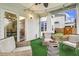 Relaxing screened-in porch with comfortable seating, turf flooring, and access to the backyard at 145 Cassada Ct, Holly Springs, NC 27540