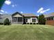 Back yard with a screened porch and a well manicured lawn at 1517 Chestnut Falls Rd, Wendell, NC 27591