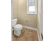 Standard bathroom features a window, toilet, and neutral wall paint at 1517 Chestnut Falls Rd, Wendell, NC 27591