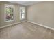 Bedroom with neutral walls, carpet, and two windows bringing in natural light at 1517 Chestnut Falls Rd, Wendell, NC 27591