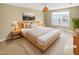 Staged main bedroom featuring a large window with a queen size bed and nightstands at 1517 Chestnut Falls Rd, Wendell, NC 27591