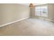 Bedroom featuring a neutral carpet, a window, and a pendant light at 1517 Chestnut Falls Rd, Wendell, NC 27591