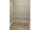 This walk in closet has multiple levels of wire racks and tile flooring at 1517 Chestnut Falls Rd, Wendell, NC 27591