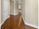 Hallway with gleaming hardwood floors and access to other rooms in the home at 1517 Chestnut Falls Rd, Wendell, NC 27591
