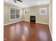 Unstaged living room with fireplace, hardwood floors, and bright natural light at 1517 Chestnut Falls Rd, Wendell, NC 27591