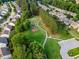 Aerial view of homes situated within green spaces and mature trees and walking paths at 1704 Fawn Chase Ct, Wake Forest, NC 27587