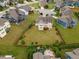 Aerial view of the beautiful home situated on a large lot featuring mature trees and green space at 1704 Fawn Chase Ct, Wake Forest, NC 27587