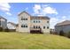 Well-maintained back yard and two-story home with a wooden deck, and lots of windows for natural light at 1704 Fawn Chase Ct, Wake Forest, NC 27587