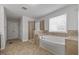 Bathroom features glass enclosed shower, soaking tub, and tiled floors at 1704 Fawn Chase Ct, Wake Forest, NC 27587