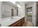 Bathroom featuring double sinks, a large mirror, and tiled floors at 1704 Fawn Chase Ct, Wake Forest, NC 27587