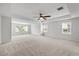 Spacious bedroom boasts neutral carpeting, ceiling fan and large window for abundant natural light at 1704 Fawn Chase Ct, Wake Forest, NC 27587