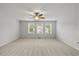 The bedroom features neutral carpet, triple windows, and great natural light at 1704 Fawn Chase Ct, Wake Forest, NC 27587