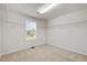 Walk-in closet includes carpet, window for natural light, and wire shelving at 1704 Fawn Chase Ct, Wake Forest, NC 27587