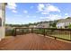 A spacious wooden deck overlooks a lush backyard and neighborhood homes at 1704 Fawn Chase Ct, Wake Forest, NC 27587