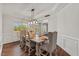 Bright dining room with hardwood floors, natural light, modern lighting, and decorative trim at 1704 Fawn Chase Ct, Wake Forest, NC 27587