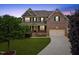 Beautiful two-story brick home with a well-manicured lawn and inviting curb appeal at 1704 Fawn Chase Ct, Wake Forest, NC 27587
