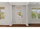 Bright foyer with hardwood floors, decorative molding, and natural light streaming through the front door at 1704 Fawn Chase Ct, Wake Forest, NC 27587