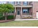 Inviting front porch with stone accents, wrought iron railing, and lush landscaping at 1704 Fawn Chase Ct, Wake Forest, NC 27587
