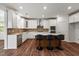 Modern kitchen features white cabinets, stainless steel appliances, and a stylish island with seating at 1704 Fawn Chase Ct, Wake Forest, NC 27587