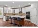 Modern kitchen features white cabinets, stainless steel appliances, and a stylish island with seating at 1704 Fawn Chase Ct, Wake Forest, NC 27587
