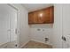 Functional laundry room offers tile flooring, overhead cabinets, and utility connections at 1704 Fawn Chase Ct, Wake Forest, NC 27587
