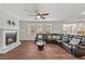Bright living room has a fireplace, large windows and a leather sectional couch at 1704 Fawn Chase Ct, Wake Forest, NC 27587