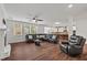 Spacious living room features a fireplace, large windows, and dark hardwood floors at 1704 Fawn Chase Ct, Wake Forest, NC 27587