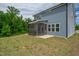Backyard view of a two-story blue house featuring a screened-in porch and lawn at 173 Forsyth Pkwy Pkwy, Clayton, NC 27520