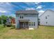 Backyard view of a two-story blue house featuring a screened-in porch and lawn at 173 Forsyth Pkwy Pkwy, Clayton, NC 27520