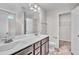 Bathroom featuring a double vanity, a large mirror, and an open view of a walk-in closet at 173 Forsyth Pkwy Pkwy, Clayton, NC 27520