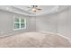 Bright, carpeted primary bedroom with trey ceilings and large window at 173 Forsyth Pkwy Pkwy, Clayton, NC 27520