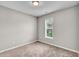 Neutral bedroom with carpet, light fixture, and a window with white blinds at 173 Forsyth Pkwy Pkwy, Clayton, NC 27520