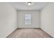 Empty bedroom with neutral carpet, a window, and fresh paint at 173 Forsyth Pkwy Pkwy, Clayton, NC 27520