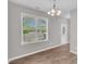 Bright dining room with modern chandelier, wood floors, and large window view at 173 Forsyth Pkwy Pkwy, Clayton, NC 27520