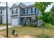 Charming two-story home with a manicured lawn and attached garage at 173 Forsyth Pkwy Pkwy, Clayton, NC 27520