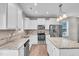 Bright kitchen featuring stainless steel appliances, granite countertops, and white cabinets at 173 Forsyth Pkwy Pkwy, Clayton, NC 27520