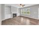 Cozy living room with fireplace, built-in shelves, and natural light from large windows at 173 Forsyth Pkwy Pkwy, Clayton, NC 27520